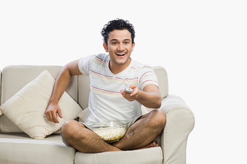 Guy with remote watching tv iStock_000073762367_Small