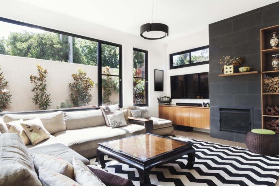 A living room with a black and white rug