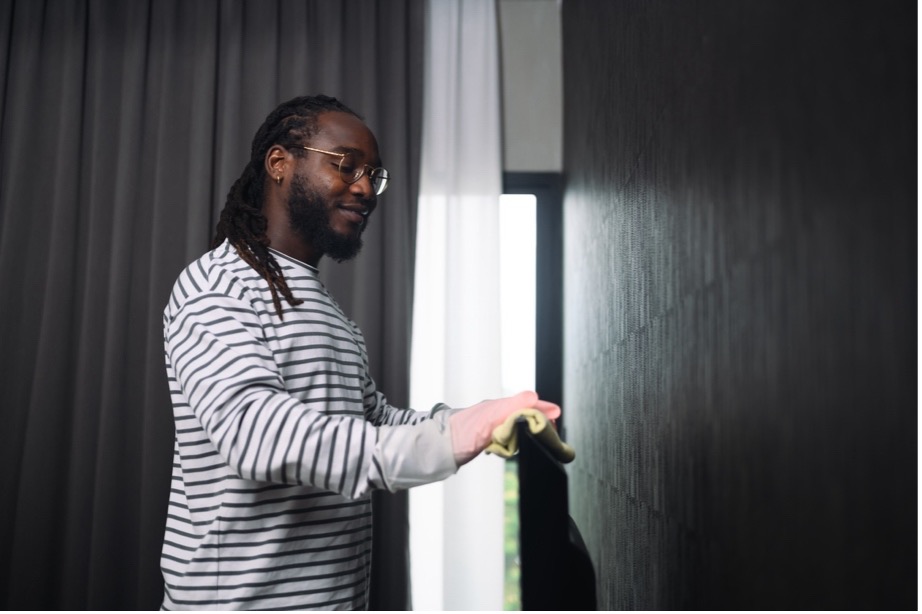 A person cleaning a television