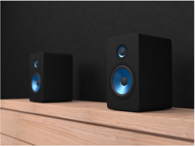 A pair of black speakers on a wooden surface